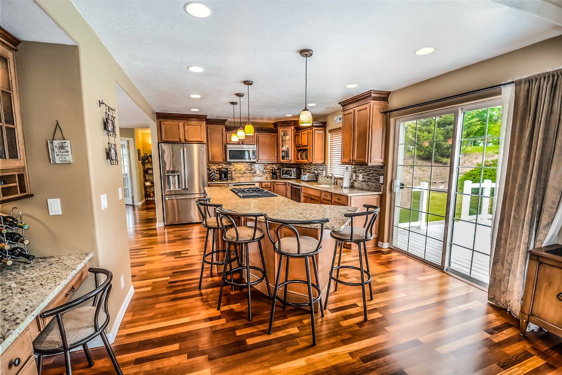 A friendly Atlanta realtor discussing details with clients inside a bright, modern home, highlighting a successful client relationship.
