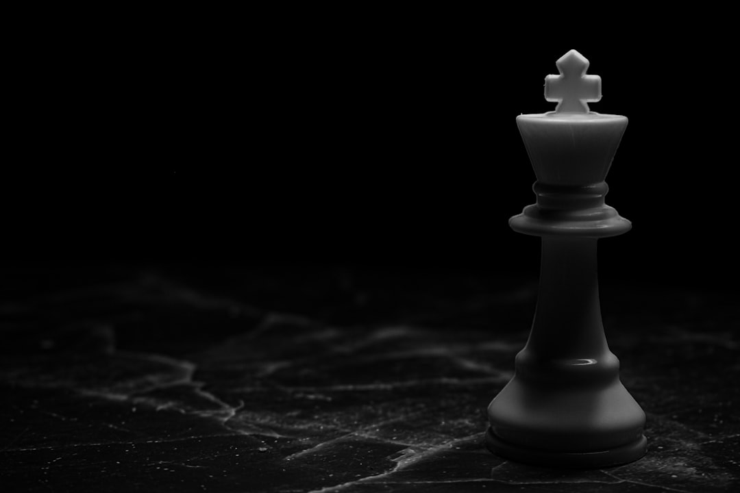 A minimal photograph of a single chess pawn strategically positioned to checkmate the king, representing a smart and winning strategy.